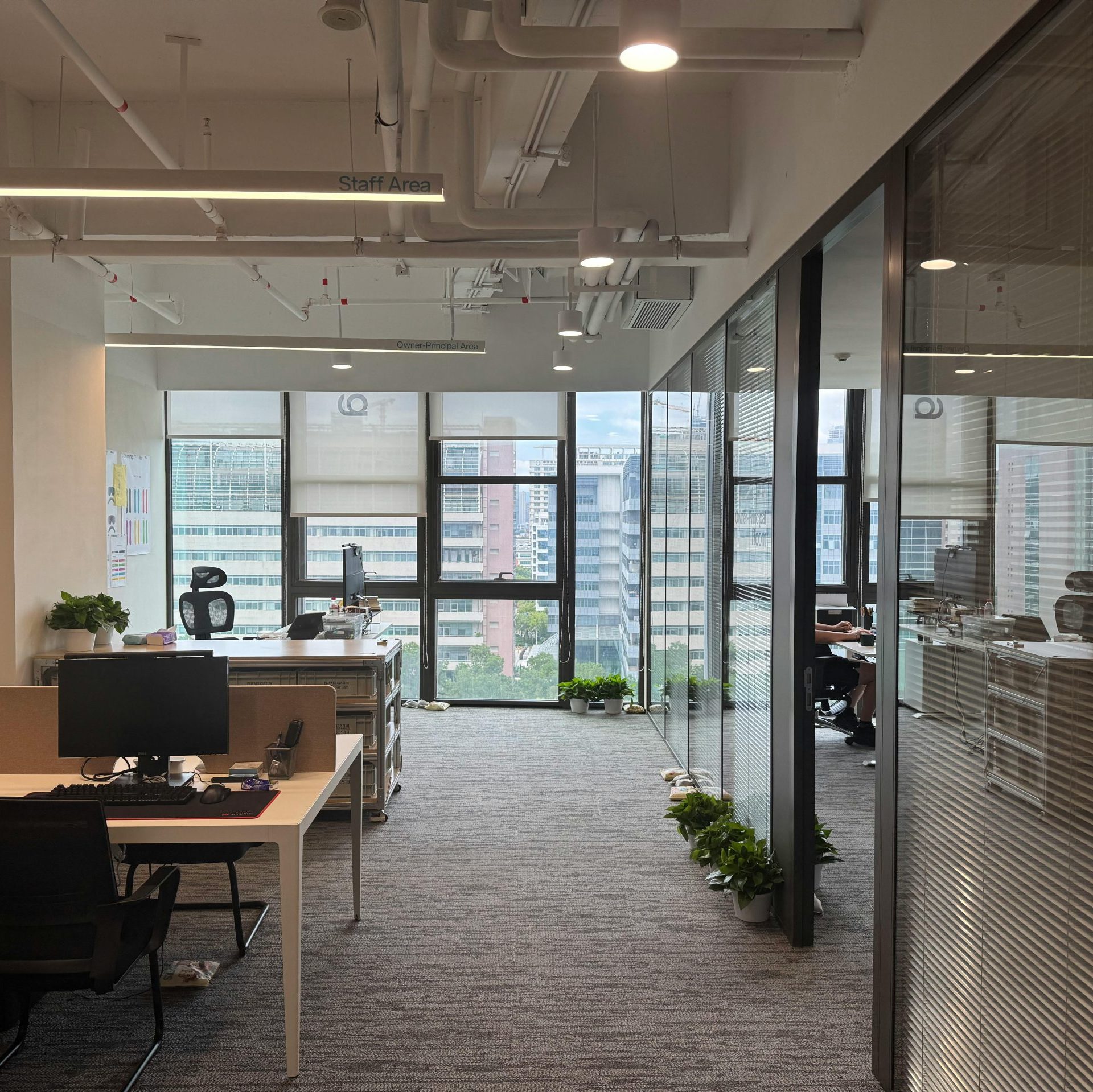 Bright, modern office interior with large windows and open workspace design.